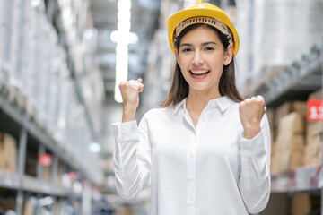 Portrait of happy female worker excited of success project or good news in distribution warehouse. complete work and high performance in logistic business, shipping and delivery service. copy space
