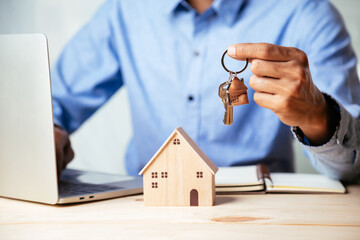 House model with real estate agent and customer discussing for contract to buy house, insurance or...
