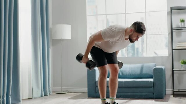 Professional sportsman practices triceps kick-backs at home