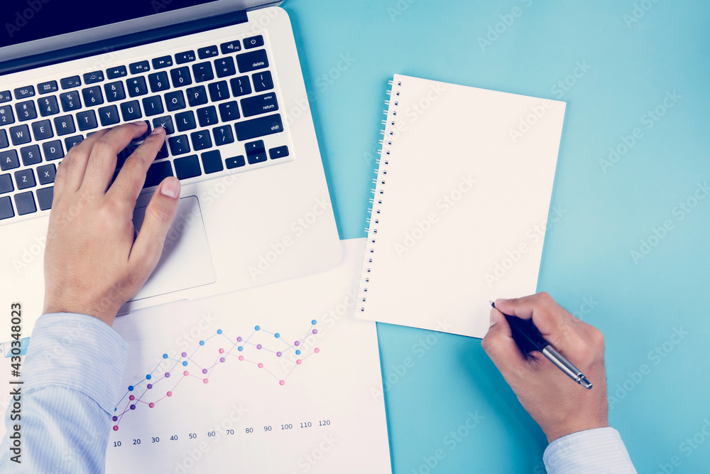 Aufkleber hand of businessman looking documents report statistic financial with graph and chart and laptop com
