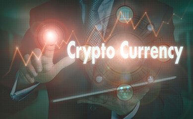 A businessman operating a computer display with a Crypto Currency business word concept on it.