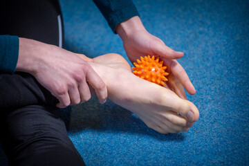 flat feet massaging with a ball