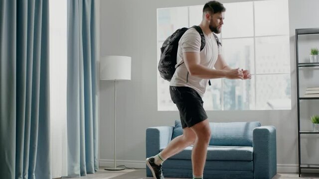 Athlete guy practices reverse lunges with weight in bag