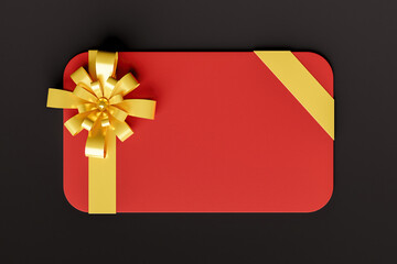 red gift card with gold ribbon on black background