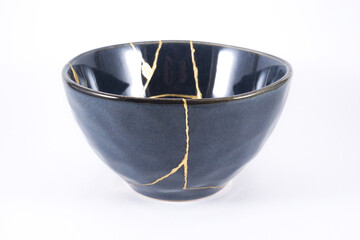 Black kintsugi bowl restored with real gold