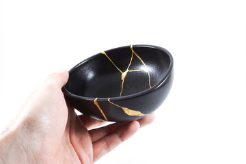 Black kintsugi bowl restored with real gold
