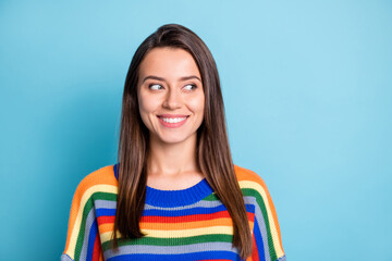 Fototapeta premium Portrait of attractive cheerful curious brown-haired girl looking aside copy space isolated over bright blue color background