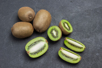 Chopped kiwi berries and whole kiwi fruits