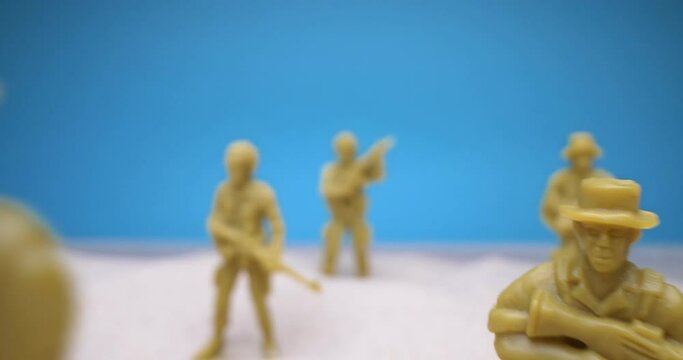 detailed extreme close-up. set of toy soldiers in the sand.