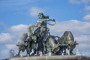View of famous Gefion Fountain (Gefionspringvandet, 1899) in Copenhagen. Gefion Fountain depicting legendary Norse goddess driving four oxen. It designed by Danish artist Anders Bundgaard. Denmark.