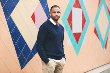 Outdoor portrait of handsome african american man, wearing blue pullover