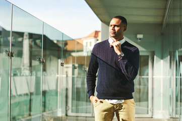 Urban portrait of African American male model posing outside