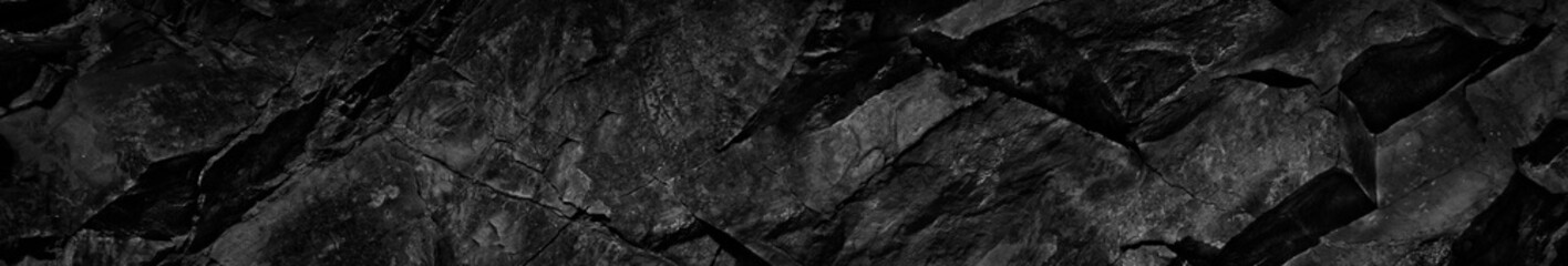 Black white rock texture. Dark stone background with copy space for design. Web banner. Website header.