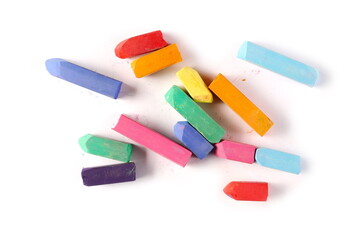 Colorful chalks pile isolated on white background, top view