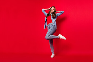 Full length body size view of attractive cheerful girl posing dancing having fun isolated over vivid red color background