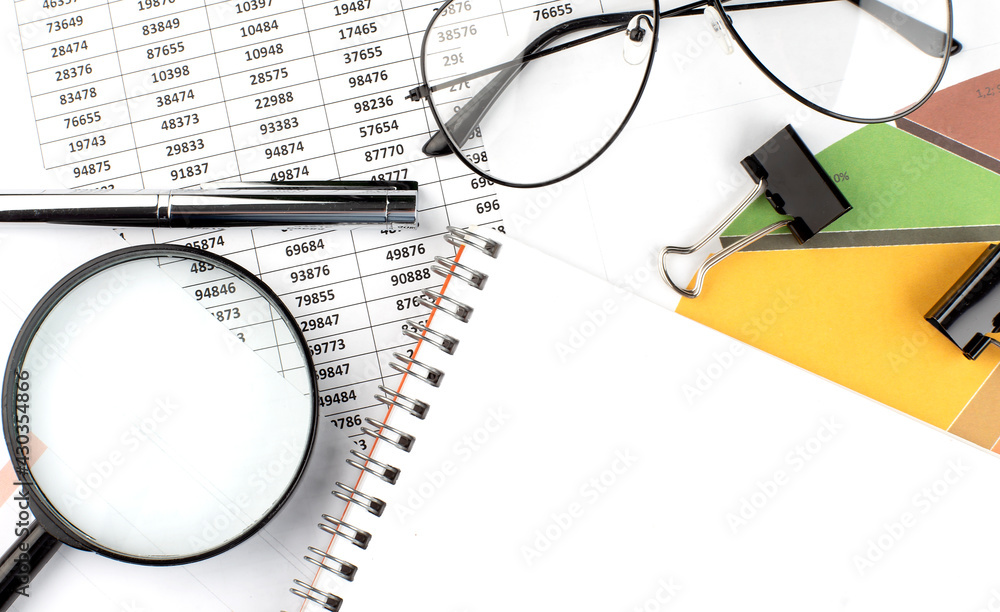 Poster the notepad and pen are on the analytical charts. open a blank notepad. copy space