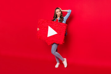 Full length body size view of attractive amazed girl holding play button board isolated over vivid...
