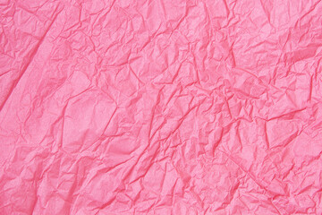 Hot pink crumpled paper texture background.