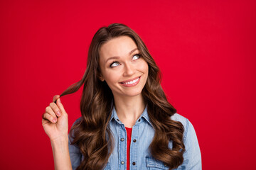 Portrait of attractive curious cheerful girl overthinking creating solution isolated over vibrant red color background