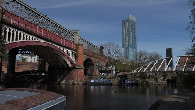 4K: Manchester, England, UK. Merchant's Bridge in Castlefield by the canal. Beetham Tower behind. Stock Video Clip Footage