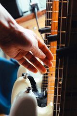 close up Image of Hand picking up guitar 