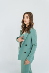 attractive young woman with a light blue suit. beautiful stylish model in an elegant fashionable monochrome suit, jacket