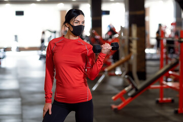 Coronavirus covid-19 prevention, fitness girl with a medical mas