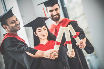 Young people in mortarboards looking happy and joyful