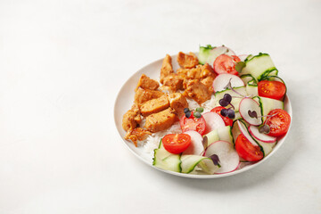 Chicken breast grill with rice and vegetables on a plate on the table. Diet nutrition.