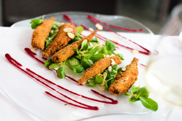 Crispy deep fried small fish  with some delicious salad and sauce