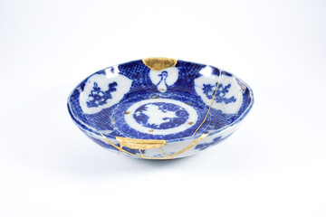 Antique white and blue Japanese plate, real gold restoration.