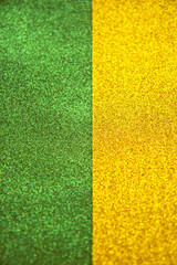 Abstract golden and green trendy backdrop. Bright holographic foil background. Colorful bright background. Flat lay