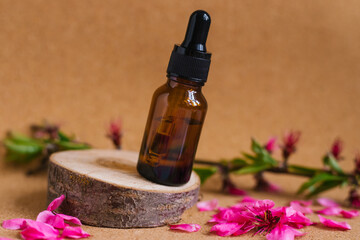 Cosmetic oil in a container with an eyedropper stands on a podium made of a cut tree. Essential oil for aromatherapy.