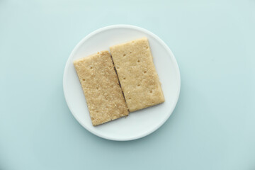 close up of sweet cookies on plate on wooden table 