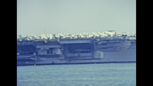 Panoramic view of USS Nimitz (CVN-68) carrier warships of United States Navy, made in 1975. Navigating in the port of Genova city in 1981. Archival of Italy in the 1980s with Genova Italian harbor.