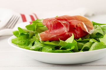 Salad, arugula leaves, with Parma prosciutto,  healthy food, top view, horizontal, no people, 