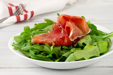 Salad, arugula leaves, with Parma prosciutto,  healthy food, top view, horizontal, no people, 