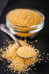 cane brown sugar on a dark stone background