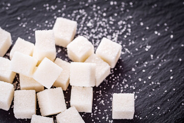 sugar refined on a dark stone background