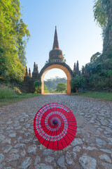 An umbrella at temple gate of Khao Na Nai Luang Dharma Park, Surat Thani, Thailand. People lifestyle in travel on holiday vacation concept. Tourist attraction.