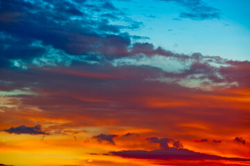 Beautiful red and yellow clouds in the summer sunset sky