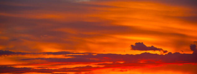 Beautiful orange clouds in the summer sunset sky