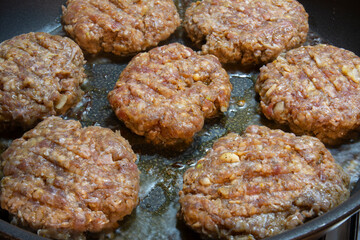  Need Three Min. Homemade burger meatballs are cooked in a cast iron pan. Selective Focus Burger meatballs.