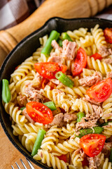 delicious traditional Italian pasta with tuna on a dark rustic stone background