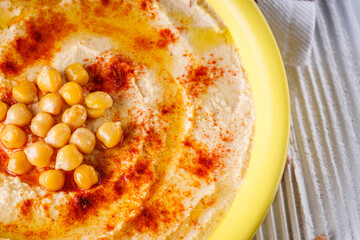 traditional turkish hummus on a white wooden rustic background