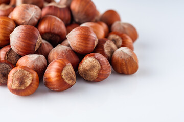 fresh natural hazelnuts on a white acrylic background