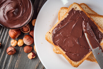 toasts with chocolate butter on a dark wooden rustic background