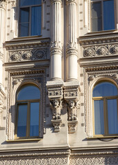 Architectural fragments of the facade of ancient historical buildings beautiful houses of a European city.