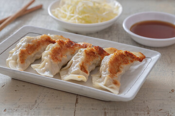 Fried dumplings Gyoza on plate and soy sauce.