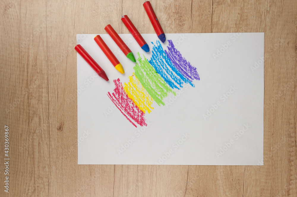 Wall mural Kid's drawn rainbow and colorful crayons on white background